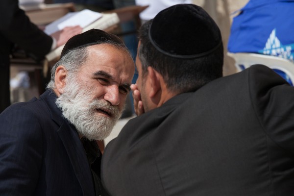 Two jewish man talking in front of the Western Wall in Jerusalem, Israel