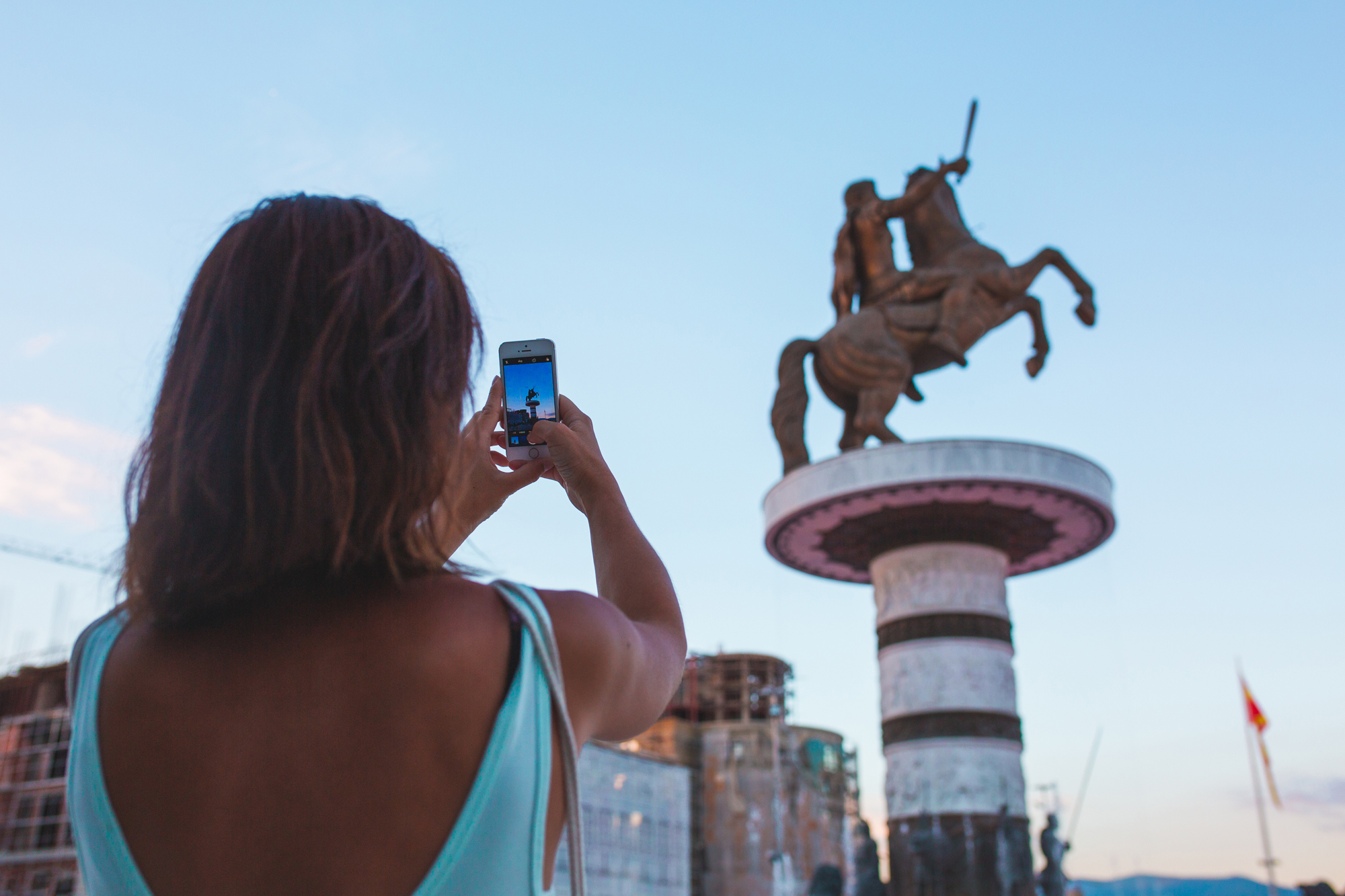 A girl making a photo with an Apple iPhone at Macedonia Square in Skopje, Macedonia