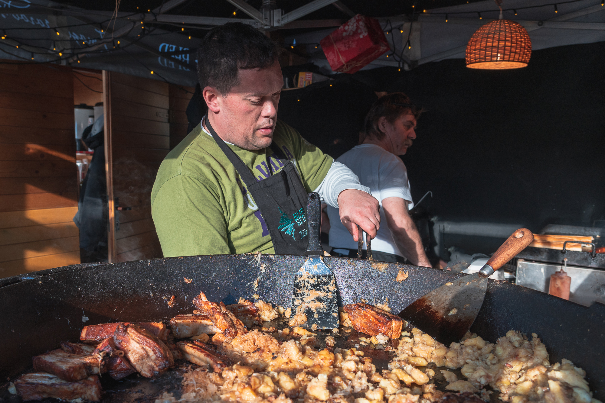 A vendor preparing food at Bled Christmas Market