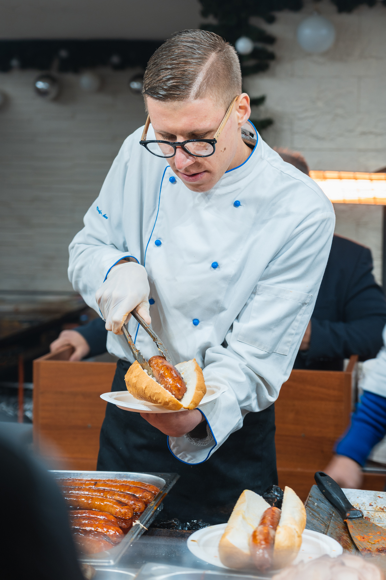A chef preparing a hot dog at the Christmas market in Budapest,